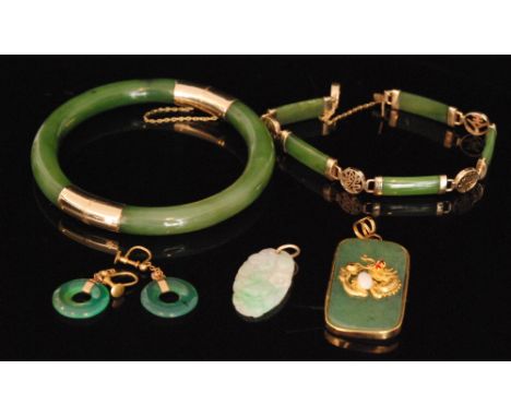 A small parcel lot of assorted 20th Century jade jewellery, a bangle, a pair of earrings, two pendants and a bracelet. (5).