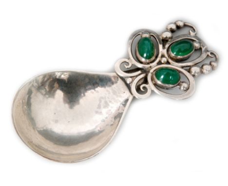 An Arts and Crafts hallmarked silver caddy spoon by Omar Ramsden, with spot hammered fig shaped bowl below applied pierced cl