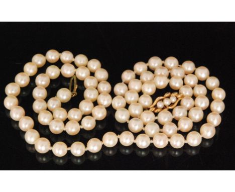 A single row of uniform cultured pearls terminating in a 9ct pearl set snap, diameter of beads 6.8mm, length 64cm. 