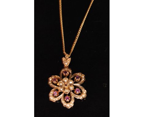 An Edwardian 9ct split pearl and amethyst flowerhead pendant below matching foliate bale, all to fine trace link chain. 