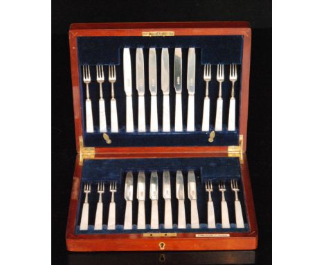 A cased set of twelve hallmarked silver mother of pearl handled fruit knives and forks all with silver blades, Sheffield 1924