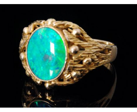 A 14ct opal ring oval collar set stone to woven gold pierced shoulders and plain band, stamped ring size M 1/2. 