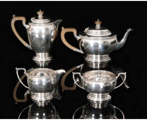 A George VI hallmarked silver four piece tea service comprising of teapot, hot water jug, sugar bowl and cream jug, of squat 