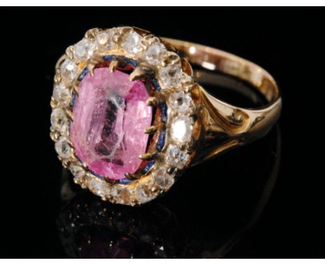 A 19th Century pink topaz and diamond cluster ring, the central oval topaz claw set and highlighted by a fine border of blue 