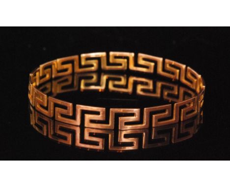 An early 20th Century 9ct rose gold slave bangle of Greek key design, weight 15g, Birmingham 1923. 