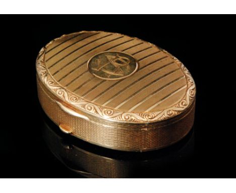 A 14ct oval snuff box, the hinged lid with engine turned decoration and embossed scroll border, central monogram to plain bas