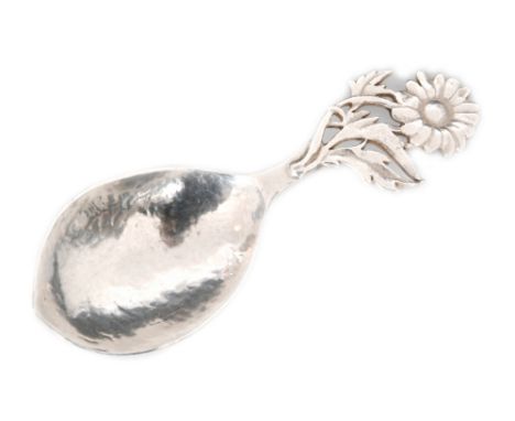 An Arts and Crafts hallmarked silver caddy spoon with hammered bowl and applied daisy design handle, engraved initials B.M.L.