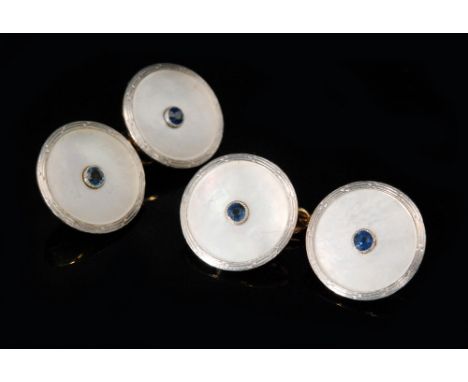 A pair of early 20th Century 18ct chain linked circular cufflinks with central sapphire to a mother of pearl ground, stamped 