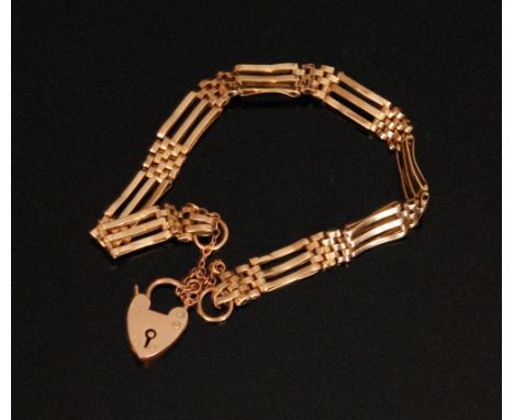 A 9ct three bar gate bracelet terminating in padlock fastener, weight 10.5g. 