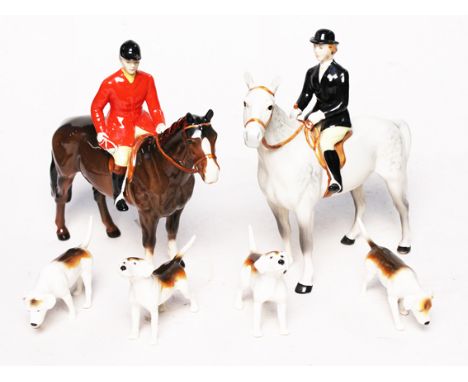 A Beswick hunting set comprising two horse and riders and four hounds