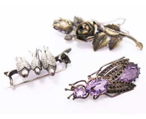 A group of three vintage brooches