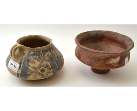 Two Chinese pottery vessels, considered to be Neolithic, both with painted decoration, one applied with a strap handle from t