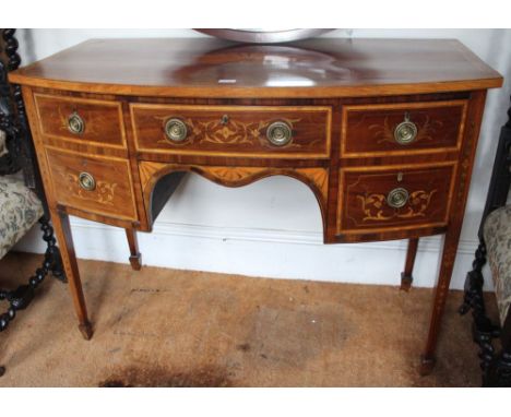 A 19th century satinwood bow fronted sideboard of Sheraton design, fitted drawers, marquetry inlaid on squared tapering suppo