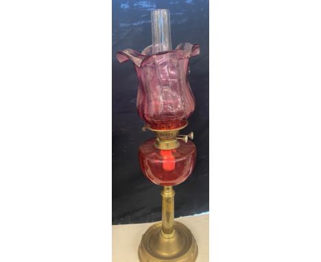 Brass oil lamp cranberry shade and font, approximate height  27 inches