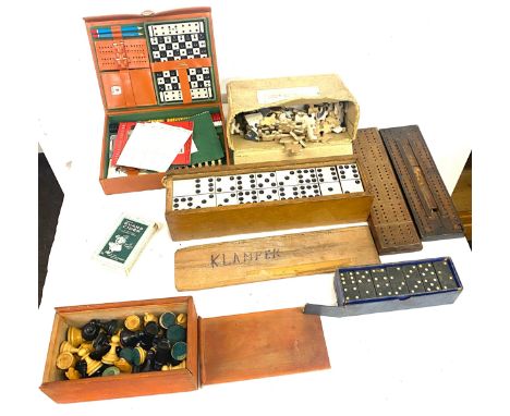 A selection of vintage games to include a 1950s games compendium, a carved wooden chess piece set, dominos, cribbage boards, 
