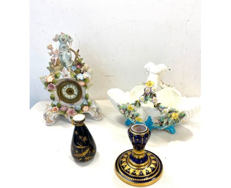 Continental clock and basket with putti plus two small pieces of derby, damaged 