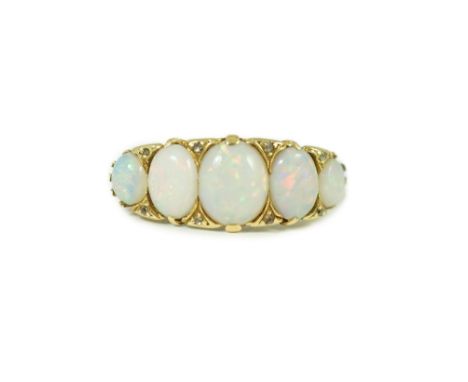 An 18ct gold and graduated five stone opal half hoop ring, with diamond chip spacers, and carved setting, size S, gross 4.8 g