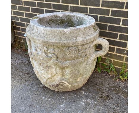 A large circular reconstituted stone garden planter with moulded serpent armorial, diameter 66cm, height 66cm