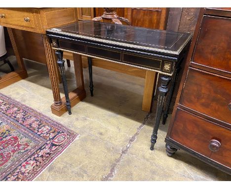 A late 19th century French gilt metal mounted ebonised rectangular folding card table, width 90cm, depth 45cm, height 76cm