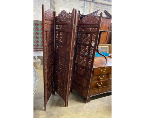 An Indian carved hardwood four fold screen, each panel width 51cm, height 183cm