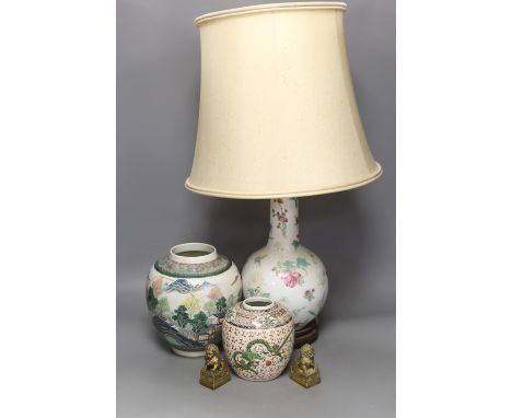 A Chinese table lamp, two Chinese Republic period enamelled porcelain jars, tallest 18.5 cm two brass lion dogs, lamp base 43