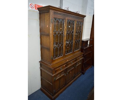 AN OLD CHARM OAK LEAD GLAZED THREE DOOR DRESSER, with three short drawers, approximate size width 134cm x height 189cm x dept