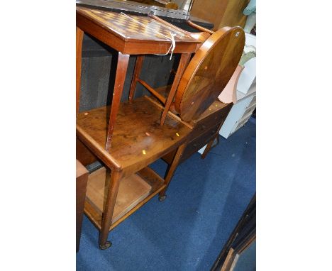 A WALNUT TROLLEY, an oak chest of two drawers, a walnut round coffee table and a musical games table (4)