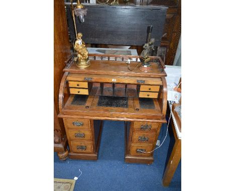  AN EARLY 20TH CENTURY WALNUT ROLL TOP DESK, with tooled leather inlay to interior, gallery top, and six drawers, approximate