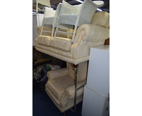 A MODERN CREAM SOFA AND CHAIR, with wooden legs and brass castors (2)