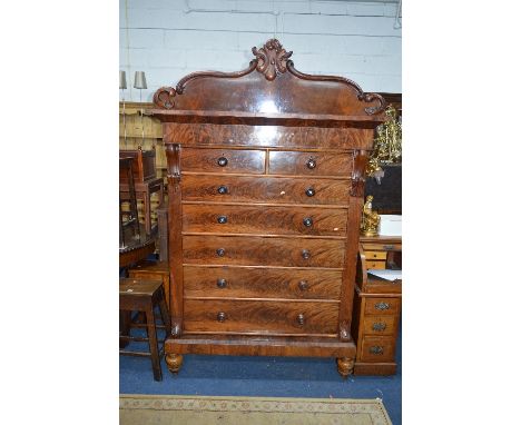 A LARGE VICTORIAN FLAME MAHOGANY CHEST, of two short and five long drawers, turned mahogany handles, carved foliate pediment 