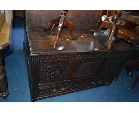 AN EARLY 20TH CENTURY CARVED OAK TRIPLE PANEL MULE CHEST, above a single long drawer