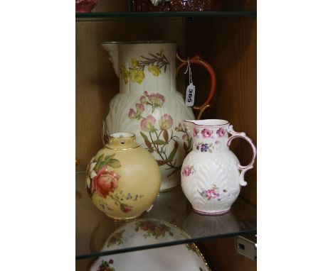 A ROYAL WORCESTER MASK JUG, late 19th Century, florally decorated, puce backstamp, height approximately 23cm (two chips to ba