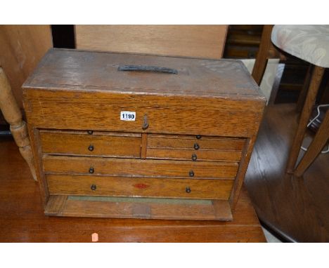 A NESLEIN OAK ENGINEERS TOOL CHEST, with seven drawers behind a lift off front and a lockable hinged lid (one key)