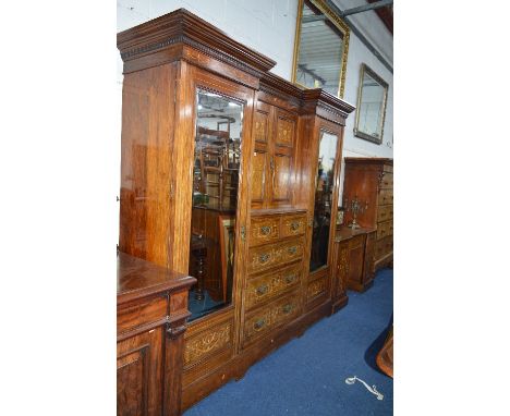 A LARGE EDWARDIAN ROSEWOOD AND INLAID COMPACTUM WARDROBE, double bevelled mirror doors flanking two short and three long draw