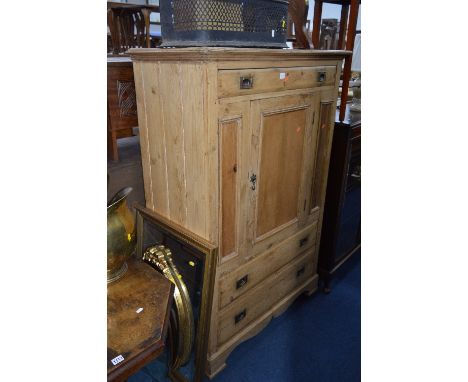 A PINE CUPBOARD, with three drawers and one central door