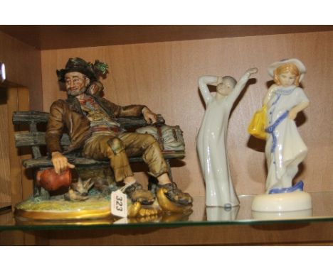 THREE VARIOUS FIGURES, to include Capodimonte Tramp on a bench, signed Volta (slight chips to hat and bird), Royal Doulton 'D