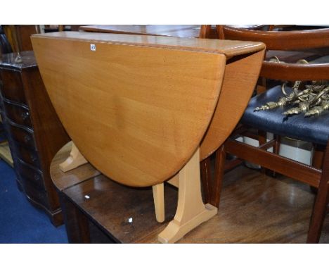AN ERCOL BLONDE ELM OVAL GATE LEG TABLE, approximate size length 140cm x depth 127cm x height 71.5cm