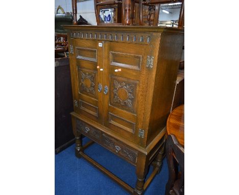 AN OLD CHARM OAK TWO DOOR DRINKS CABINET, with two drawers