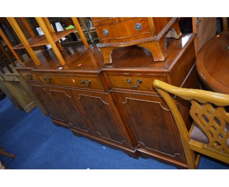 A YEW WOOD BREAKFRONT SIDEBOARD, with three various drawers and cupboard base, approximate size width 181cm x depth 45cm x he