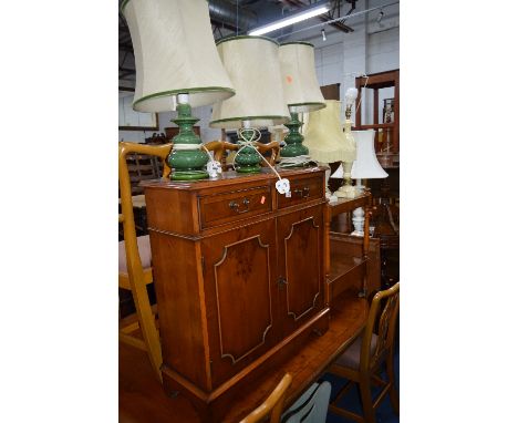 A SLIM YEW WOOD HALL CABINET, with two drawers, similar two tier trolley, painted crib and six various table lamps (9)