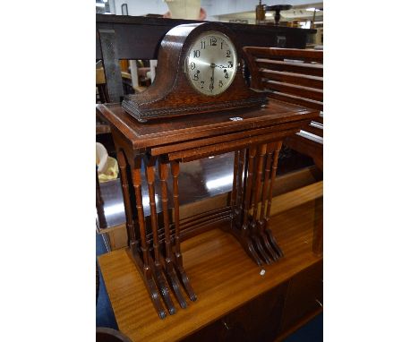 A MODERN MAHOGANY NEST OF FOUR TABLES (Bradleys label to underside) and an oak mantel clock (2)