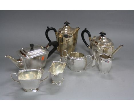 AN EPNS FOUR PIECE PANELLED OVAL TEA SERVICE, marked J.B.C & S Ltd, together with an Art Deco style three piece EPNS tea serv