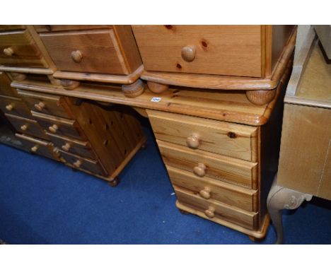 A PINE DRESSING TABLE, with eight drawers