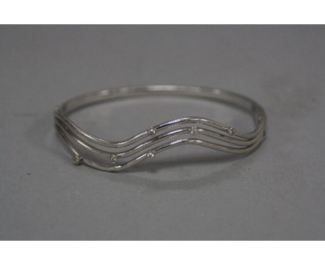 A 9CT WHITE GOLD DIAMOND BANGLE