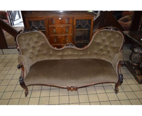 A VICTORIAN ROSEWOOD BUTTON BACK UPHOLSTERED SOFA, with foliate carving