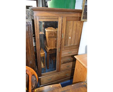 A WALNUT COMPACTUM MIRROR DOOR WARDROBE, oposing a single door, three short drawers above a single long drawer