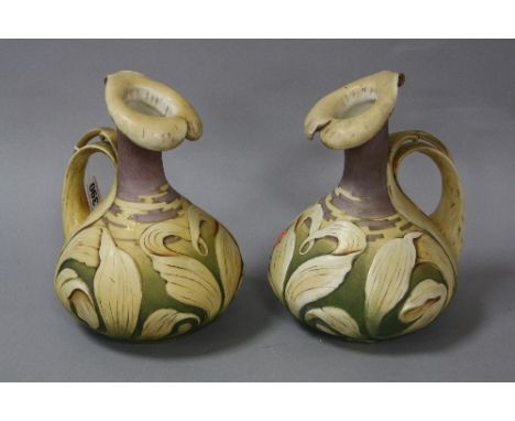 A PAIR OF ART NOUVEAU AUSTRIAN PORCELAIN JUGS, having naturalistic rim, handle and body, impressed marks, height approximatel