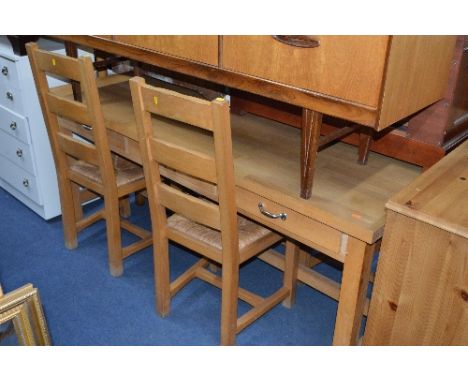 A MODERN BEECHWOOD KITCHEN TABLE, with three full drawers and four rush seated chairs