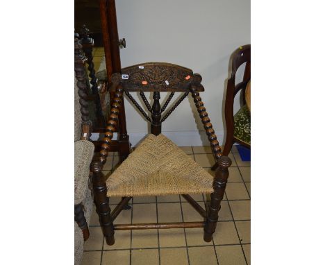 A CARVED OAK BOBBIN TURNED TURNER CHAIR, with rush seat