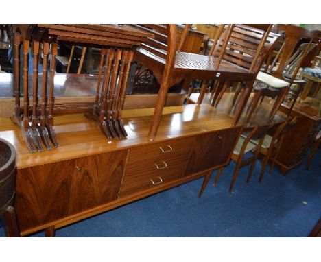 A TEAK SIDEBOARD, with three central drawers and two rosewood fronted cupboards and a teak extending dining table and six cha